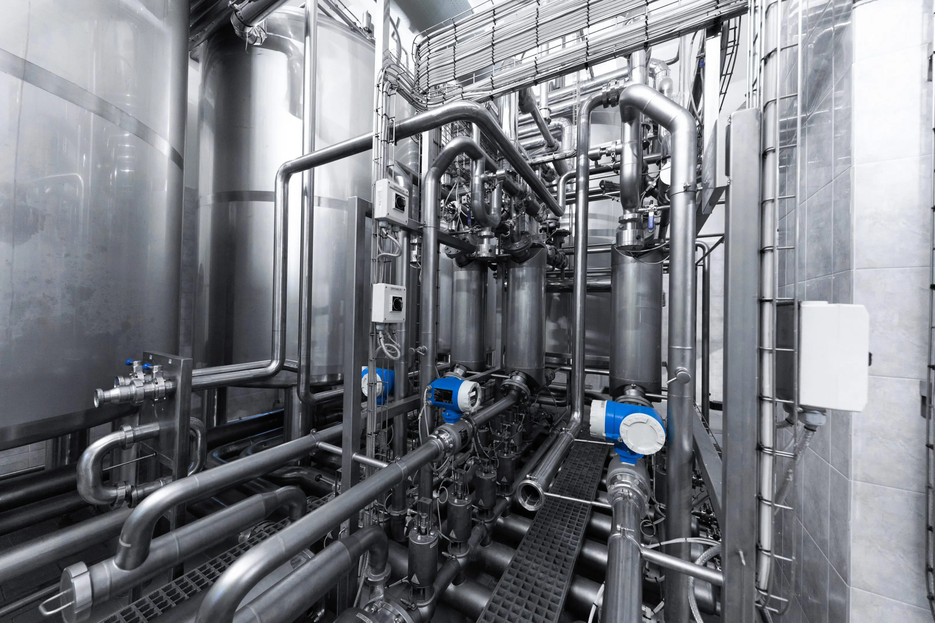Industrial facility with complex piping and machinery.