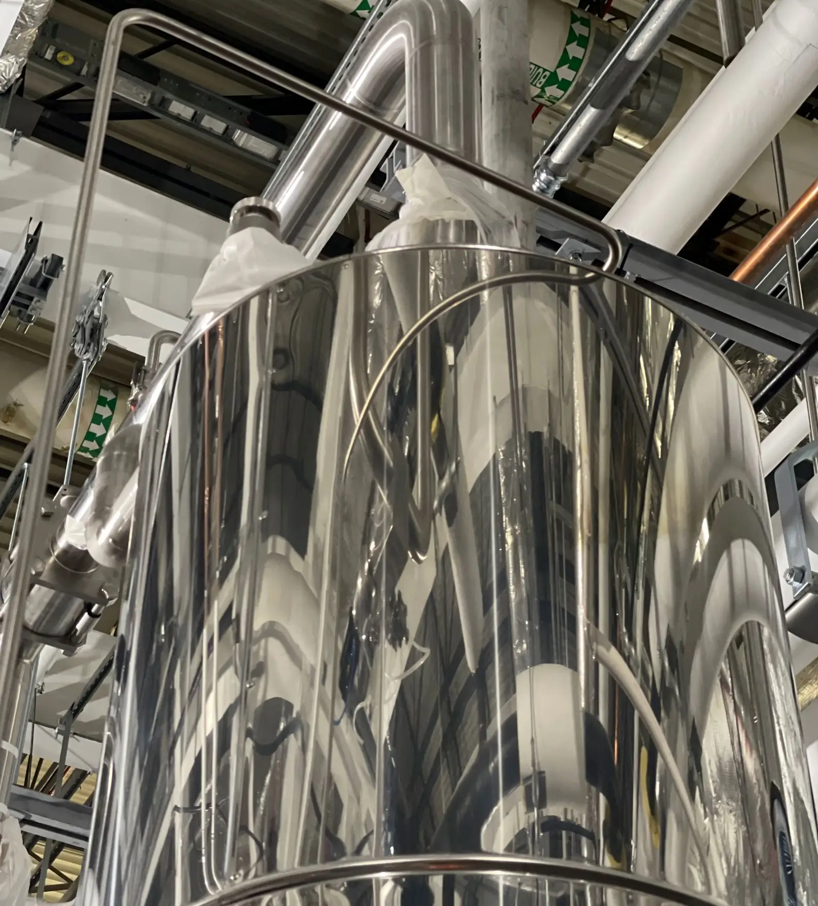 Shiny metal industrial equipment in a factory setting.