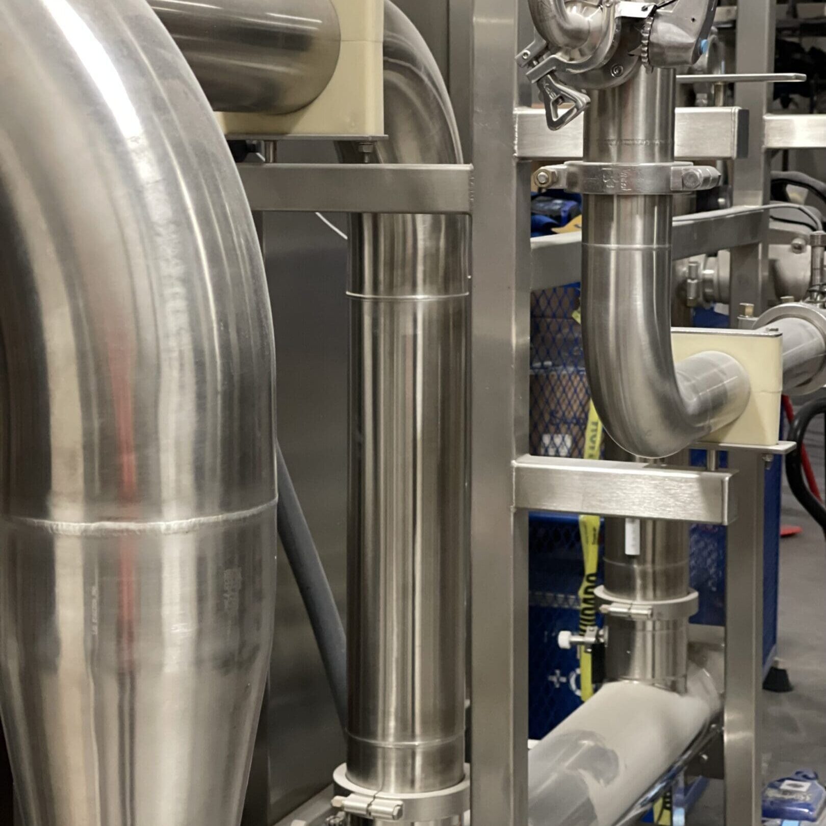 Close-up of industrial stainless steel pipes and valves.